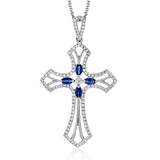 This 18k white gold cross pendant contains .36 ctw round brilliant white diamonds as well as .35 ctw of marquise shaped blue sapphires.