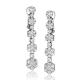 These lovely 18k white gold earrings feature a line of flowers set with 2.65 ctw of white diamonds.