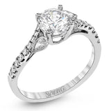 This lovely 18k white gold engagement ring contains .20 ctw of white round brilliant diamonds, highlighted by .10 pear shaped white diamonds.