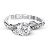 This lovely 18k white gold engagement ring contains .20 ctw of white round brilliant diamonds, highlighted by .10 pear shaped white diamonds.