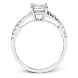 This lovely 18k white gold engagement ring contains .20 ctw of white round brilliant diamonds, highlighted by .10 pear shaped white diamonds.