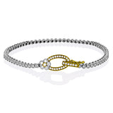 This two tone 18k white and rose gold buckle bracelet contains .98 ctw of white round brilliant diamonds, a .02 ct pink diamond, and a tiny flower design.