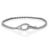This two tone 18k white and rose gold buckle bracelet contains .98 ctw of white round brilliant diamonds, a .02 ct pink diamond, and a tiny flower design.