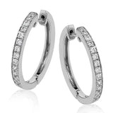 These medium-sized hoop earrings feature .50 ctw of white diamonds and are crafted from 18k white gold.
