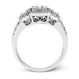 This balanced, geometric 18k white gold design showcases .46 ctw of round diamonds, .32 ctw of baguette diamonds, and .36 ctw of emerald cut diamonds.