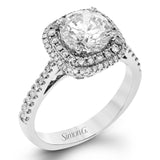 This classic style ring is formed from 18k white and rose gold. The halo design is set with .25 ctw of white diamonds as well as .18 ctw of pink diamonds.