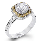 This classic style ring is formed from 18k white and rose gold. The halo design is set with .25 ctw of white diamonds as well as .18 ctw of pink diamonds.