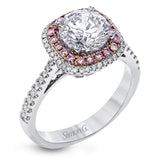 This classic style ring is formed from 18k white and rose gold. The halo design is set with .25 ctw of white diamonds as well as .18 ctw of pink diamonds.