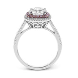 This classic style ring is formed from 18k white and rose gold. The halo design is set with .25 ctw of white diamonds as well as .18 ctw of pink diamonds.