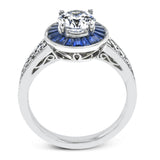 This 18k white gold engagement ring add something special with .56 ctw of baguette sapphires in a halo around the center stone. A total of .36 ctw of white diamonds finish this remarkable design.