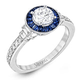 This 18k white gold engagement ring add something special with .46 ctw of baguette sapphires in a halo around the center stone. A total of .13 ctw of white diamonds and an additional .13 ctw of baguette diamonds finish this remarkable design.