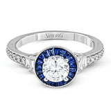 This 18k white gold engagement ring add something special with .46 ctw of baguette sapphires in a halo around the center stone. A total of .13 ctw of white diamonds and an additional .13 ctw of baguette diamonds finish this remarkable design.