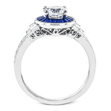 This 18k white gold engagement ring add something special with .46 ctw of baguette sapphires in a halo around the center stone. A total of .13 ctw of white diamonds and an additional .13 ctw of baguette diamonds finish this remarkable design.