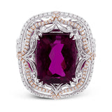 This vintage-inspired two-tone 18k gold ring centers on an extraordinary 7.03 rubellite stone which is surrounded by .67 ctw of white diamonds.