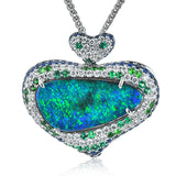 This unique pendant is made to fit an incredible 16.84 ctw opal center stone. The pendant is set with .83 ctw of diamonds, sapphires and tsavorite garnet to set off the opal's distinctive colors.