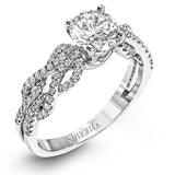 This distinctive 18k white gold ring has an intricate design reminiscent of lover's knots and eternity symbols, set with .33 ctw of white diamonds.