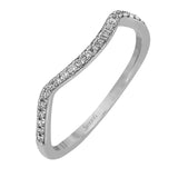 This sparkling modern engagement ring features an eye-catching twisted design with elegant classic halo accented by .29 ctw of shimmering round cut white diamonds.