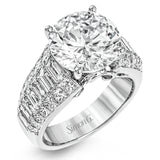 Crafted from 18k white gold, this modern engagement ring commends attention with 1.34 ctw of princess cut diamonds in combination with 1.42 ctw of baguette diamonds.