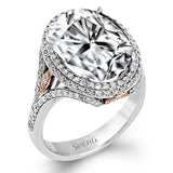 A beautiful 7.55 ct oval rubellite sits at the center of this enchanting 18k white gold ring with accents of 18k rose gold. A beautiful .70 ctw of white diamonds finishes this lovely design.