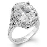 A beautiful 7.55 ct oval rubellite sits at the center of this enchanting 18k white gold ring with accents of 18k rose gold. A beautiful .70 ctw of white diamonds finishes this lovely design.