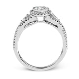This 18k white gold wedding set has a distinctive design with a milgrain accented bezel center stone setting, .15 ctw pear side stones, and .50 ctw of round brilliant diamonds.