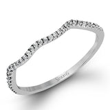 This 18k white gold wedding set has a distinctive design with a milgrain accented bezel center stone setting, .15 ctw pear side stones, and .50 ctw of round brilliant diamonds.
