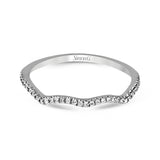 This 18k white gold wedding set has a distinctive design with a milgrain accented bezel center stone setting, .15 ctw pear side stones, and .50 ctw of round brilliant diamonds.