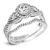 This 18k white gold wedding set has a distinctive design with a milgrain accented bezel center stone setting, .15 ctw pear side stones, and .50 ctw of round brilliant diamonds.