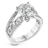This 18k white gold engagment ring is a modern take on a classic design with 1.12 ctw of round white diamonds.