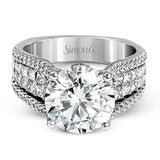 This bold 18k white gold engagement setting contains 1.04 ctw of princess cut diamonds alongside .40 ctw of round brilliant diamonds.