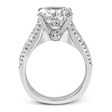 This bold 18k white gold engagement setting contains 1.04 ctw of princess cut diamonds alongside .40 ctw of round brilliant diamonds.