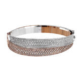 This striking bangle bracelet contains a stunning 4.69 ctw of white diamonds set into a 18k white and rose gold design.