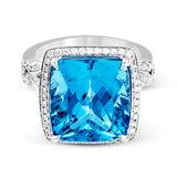 A bright blue 9.57 ct aquamarine is the central focus of this classic halo 18k white gold ring set with .68 ctw of white diamonds.