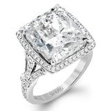 A bright blue 9.57 ct aquamarine is the central focus of this classic halo 18k white gold ring set with .68 ctw of white diamonds.