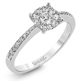 This delightful ring is crafted from 18k white gold and features a .30 ct white diamond in the center of .50 ctw of smaller round white diamonds.
