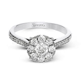 This delightful ring is crafted from 18k white gold and features a .30 ct white diamond in the center of .50 ctw of smaller round white diamonds.