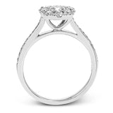 This delightful ring is crafted from 18k white gold and features a .30 ct white diamond in the center of .50 ctw of smaller round white diamonds.