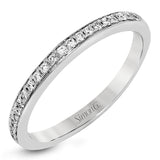 This delightful ring is crafted from 18k white gold and features a .30 ct white diamond in the center of .50 ctw of smaller round white diamonds.