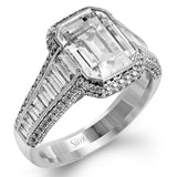 This 18k white and rose gold ring has a clean, graduated design with .84 ctw of baguette diamonds leading up to the center stone. The edges are bordered by .49 ctw of pink diamonds set into rose gold.