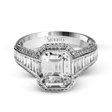 This 18k white and rose gold ring has a clean, graduated design with .84 ctw of baguette diamonds leading up to the center stone. The edges are bordered by .49 ctw of pink diamonds set into rose gold.