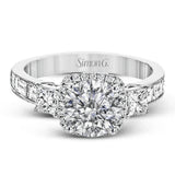 The impressive circular halo of this white gold engagement ring is set with .10 ctw round cut white diamonds and emphasized by .43 ctw princess cut diamonds and .58 baguette cut diamonds.
