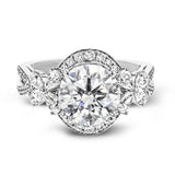 Dramatic yet romantic, this exquisite white gold engagement ring features .61 ctw of round cut white diamonds highlighted by .58 ctw of pear shaped diamonds in delicate floral motifs.