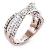This modern 18k two-tone gold ring stands out from the crown with an overlapping design set with .42 ctw of round diamonds and .65 ctw of baguette diamonds.