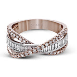 This modern 18k two-tone gold ring stands out from the crown with an overlapping design set with .42 ctw of round diamonds and .65 ctw of baguette diamonds.