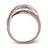 This modern 18k two-tone gold ring stands out from the crown with an overlapping design set with .42 ctw of round diamonds and .65 ctw of baguette diamonds.