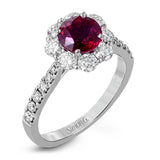 This splendid white gold ring features a 1.53 ctw round ruby highlighted by 1.00 ctw of round white diamonds adorning the halo and shank.
