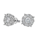 These 18k white gold stud earrings feature .50 ctw diamond centers surrounded by .57 ctw of smaller round white diamonds.