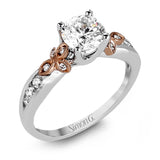 This delicate white gold ring features lovely rose gold accents on the shank and is set with .24 ctw of round cut white diamond accents.