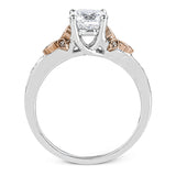 This delicate white gold ring features lovely rose gold accents on the shank and is set with .24 ctw of round cut white diamond accents.