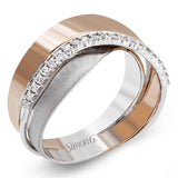 This unique band in two-tone 18k gold has a modern, organic design with rose and white gold overlapping, accented by a line of .16 ctw of white diamonds.
